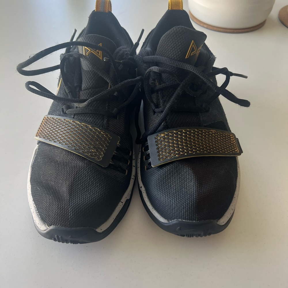 Nike Black and Gold Athletic Shoes with Streamlined Design